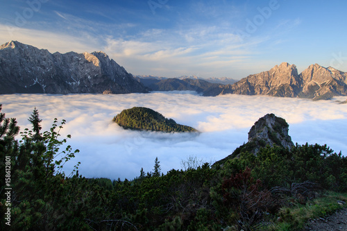 Sunrise above sea of clouds photo