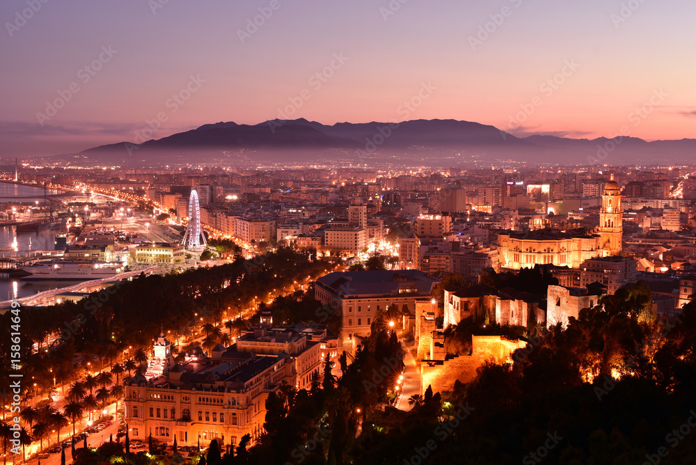 Malaga cathedral and cityscape at twilight from aerial view