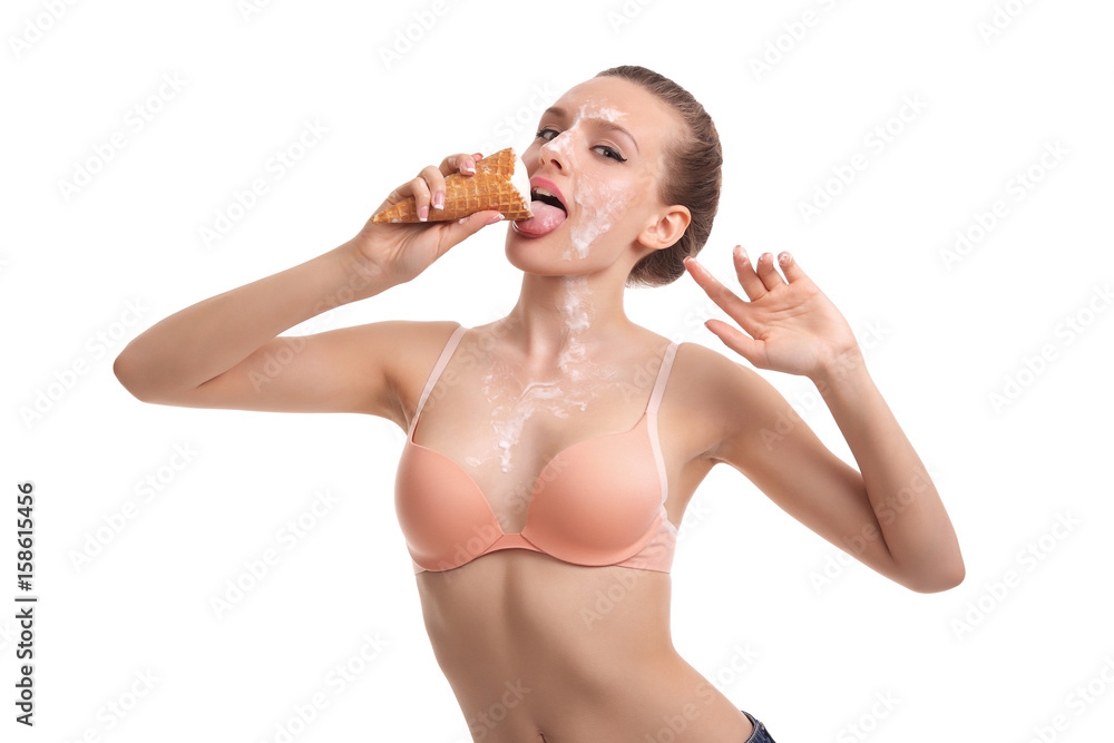 woman eats icecream in studio , ice cream dripping on the face and breast girl. woman eats icecream in studio , ice cream dripping on the face and breast girl.
