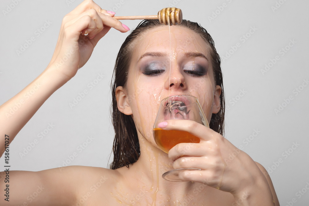 Beautiful woman with honey on her face Beautiful woman with honey on her face
