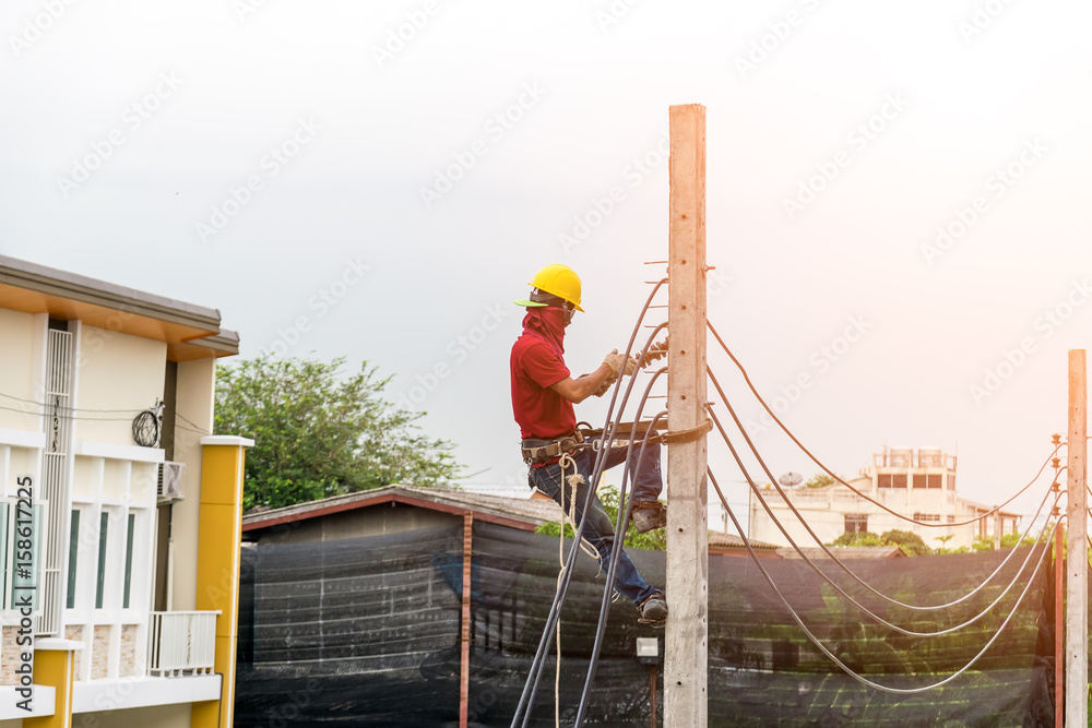 Electricians are climbing on electric poles to install power lines. Electricians are climbing on electric poles to install power lines.