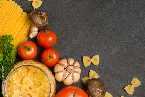 Italian food concept. Pasta ingredients. Cherry-tomatoes, spaghetti pasta, rosemary and spices