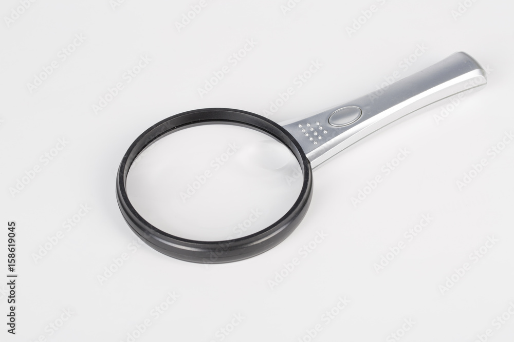 One modern magnifying glass on white bakground. One modern magnifying glass on white bakground.