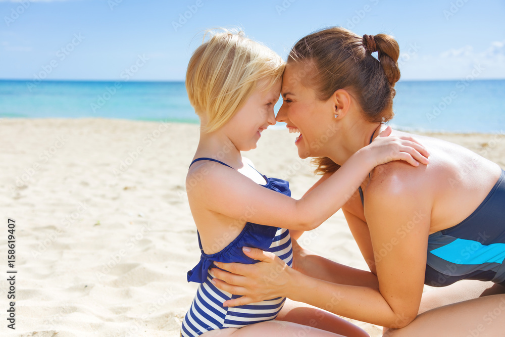 happy healthy mother and child on seacoast embracing happy healthy mother and child on seacoast embracing