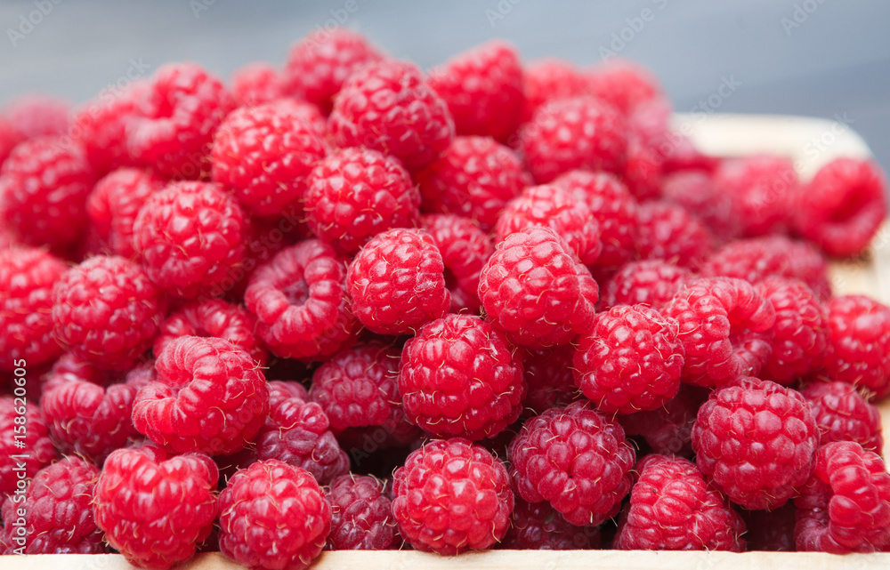 Basket with raspberries closeup, summer harvest Basket with raspberries closeup, summer harvest