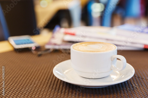 Cup of cappuccino coffee on table