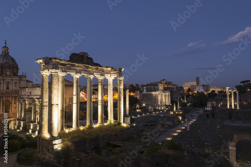 Ancient ruins at forum romanum in Rome at dusk, Italy
