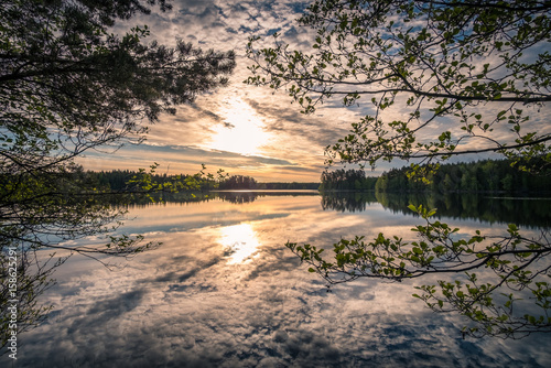 Scenic landscape with lake and sunrise at summer morning in national park Liesjärvi, Finland