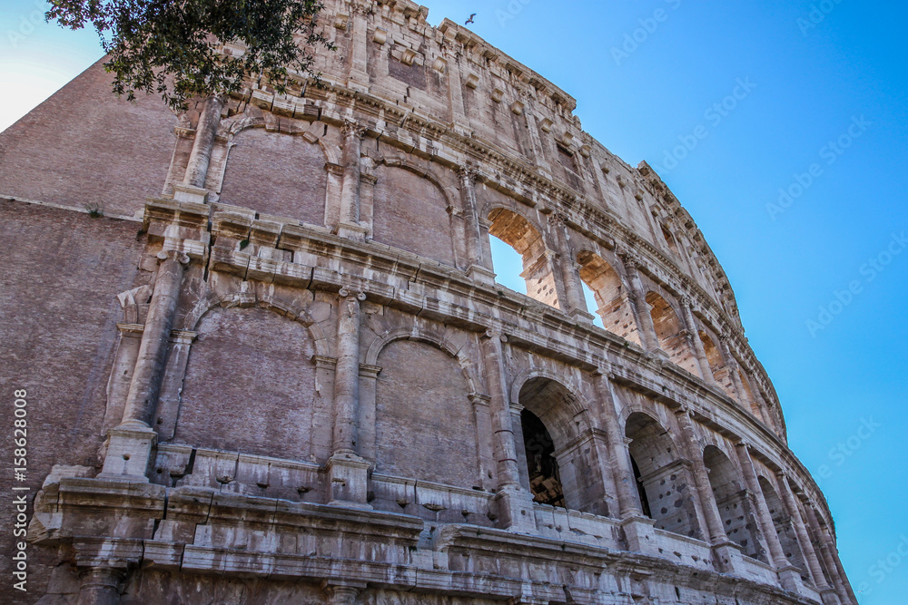 Obraz premium View of Colosseum in Rome and morning sun, Italy, Europe.