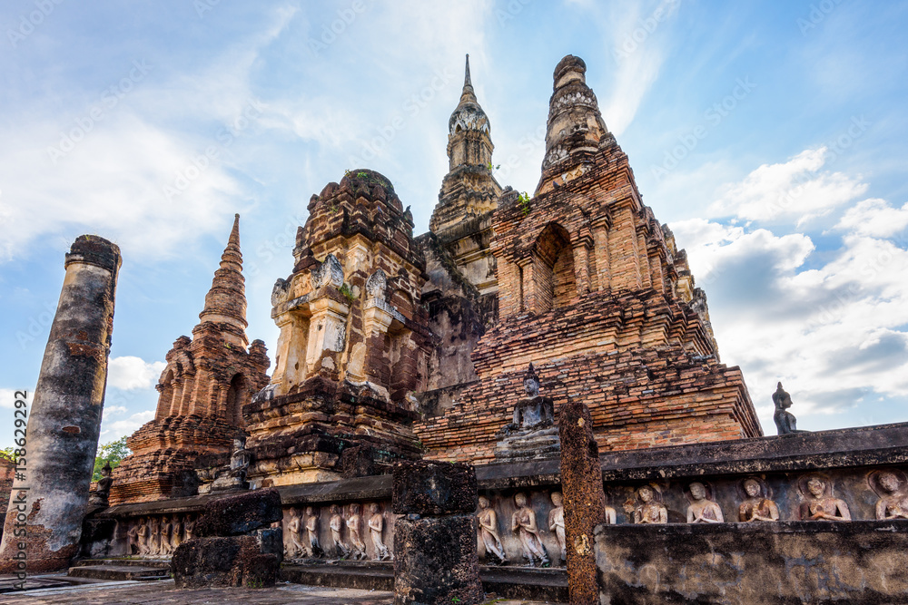 Ancient brick chapel under the blue sky at Wat Maha That temple in Sukhothai Historical Park is an old capital and famous landmark of Sukhothai Province, Thailand