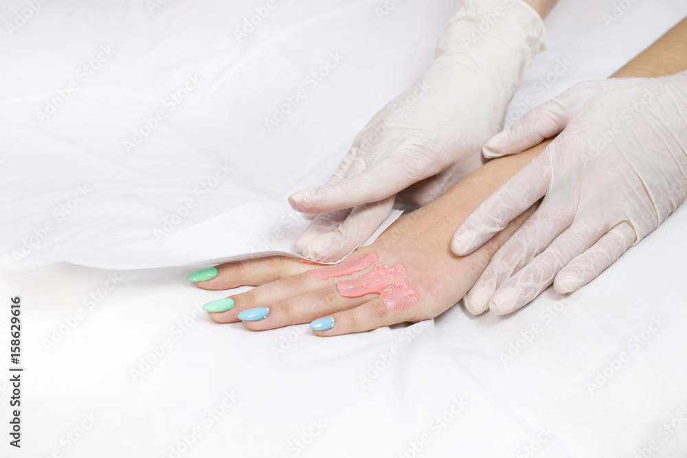 Process depilation female legs and hands in a beauty salon Process depilation female legs and hands in a beauty salon