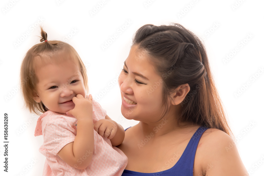 Beautiful and stylish pregnant mother with long hair holding daughter with hands in the air. Beautiful and stylish pregnant mother with long hair holding daughter with hands in the air.