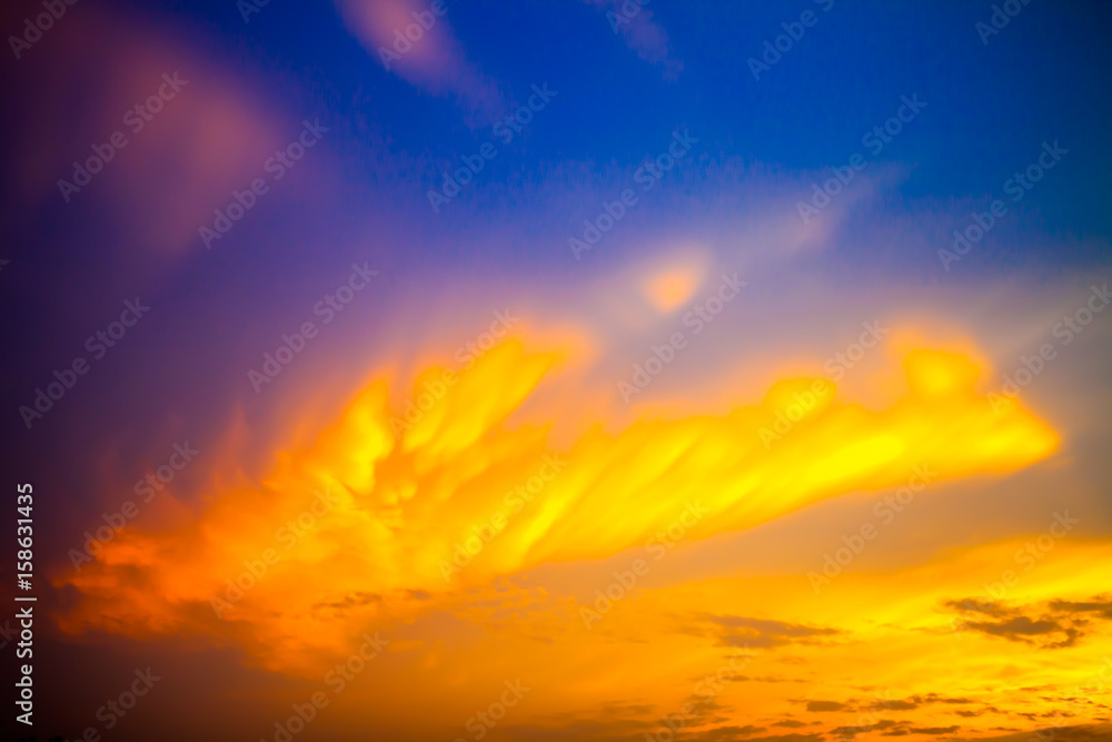 golden clouds on blue sky sunrise background Blur or Defocus image.