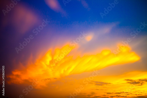 Fototapeta Naklejka Na Ścianę i Meble -  golden clouds on blue sky sunrise background Blur or Defocus image.