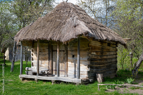 National Museum Pirogovo in the outdoors near Kiev. Ancient rural Ukrainian old wooden building with a thatched roof, spring landscape in the old village of national architecture, Ukraine.