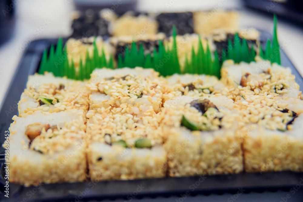 Fresh and delicious maki and nigiri sushi and sake glass.