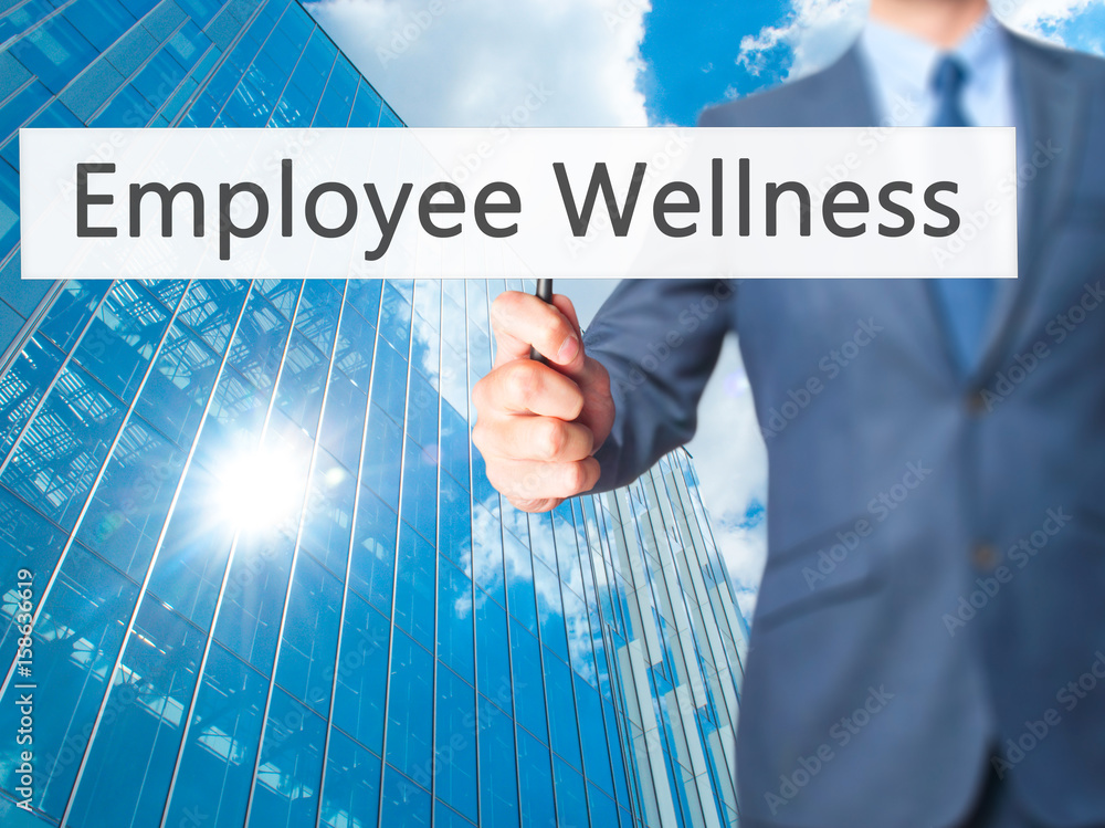 Employee Wellness - Businessman hand holding sign Employee Wellness - Businessman hand holding sign