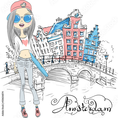 Fashionable hipster girl tourist with skateboard near the bridge on the Amsterdam street with traditional Dutch houses, Holland, Netherlands.