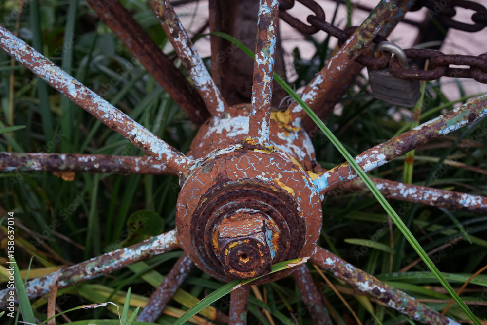 Old Weathered Wagon Wheel With Rust And Yellow Blue Spots Old Weathered Wagon Wheel With Rust And Yellow Blue Spots