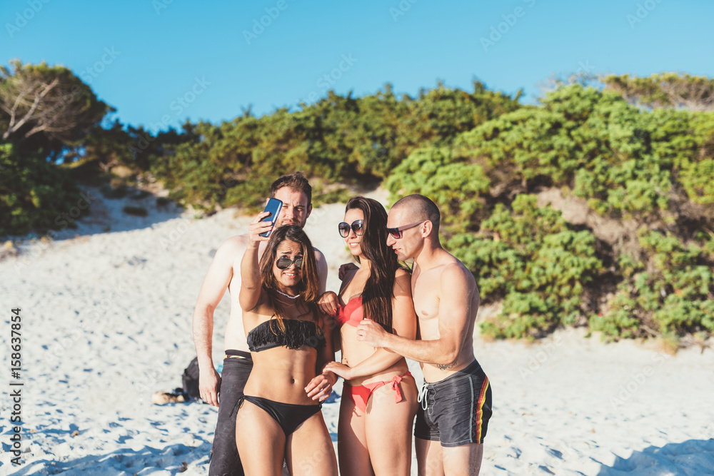 Group of friends millennials using smart phone taking selfie - social network, friendship, having fun concept Group of friends millennials using smart phone taking selfie - social network, friendship, having fun concept