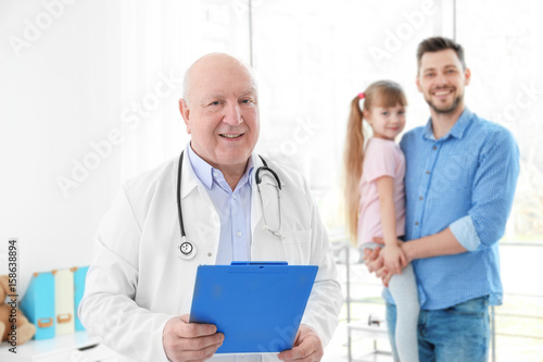 Senior doctor with patients...