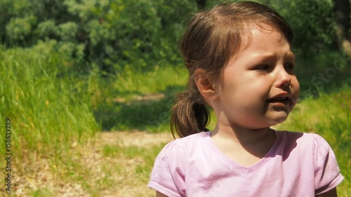 Tears of a little girl. Emotions of a child in nature.