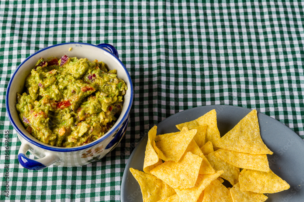 Bowl of guacamole with tortilla chips Bowl of guacamole with tortilla chips