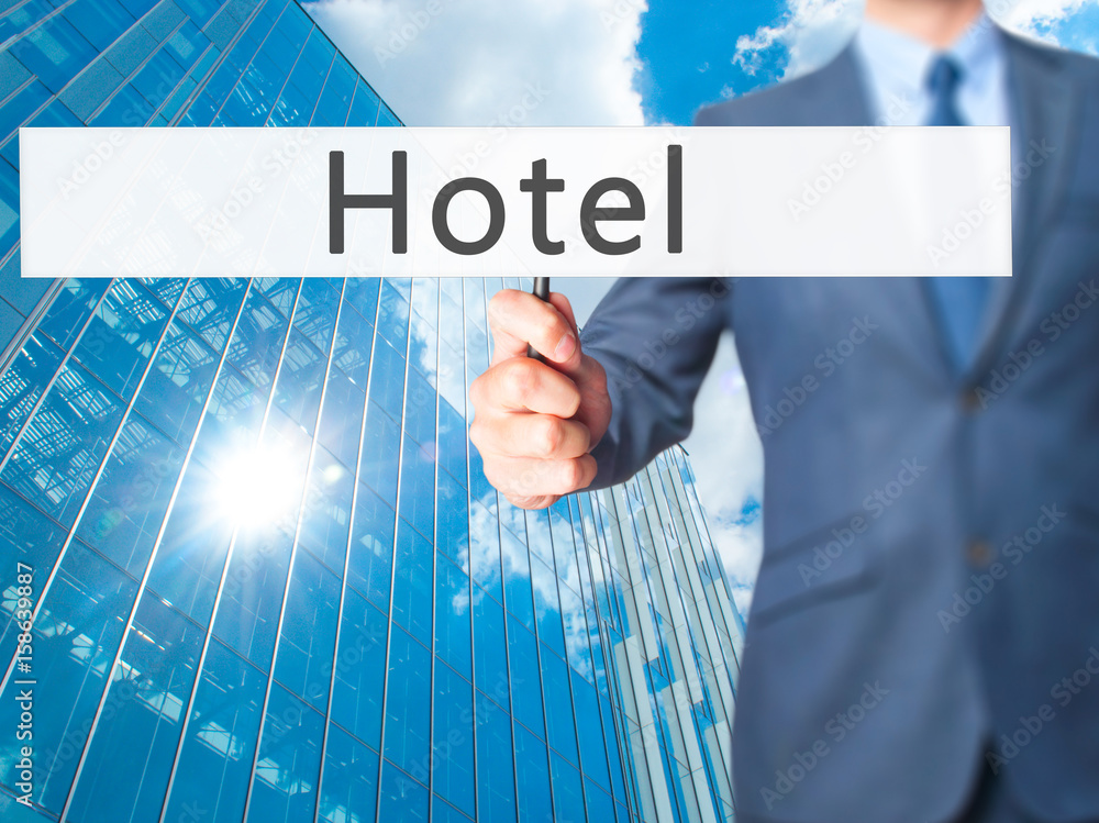 Hotel - Businessman hand holding sign Hotel - Businessman hand holding sign