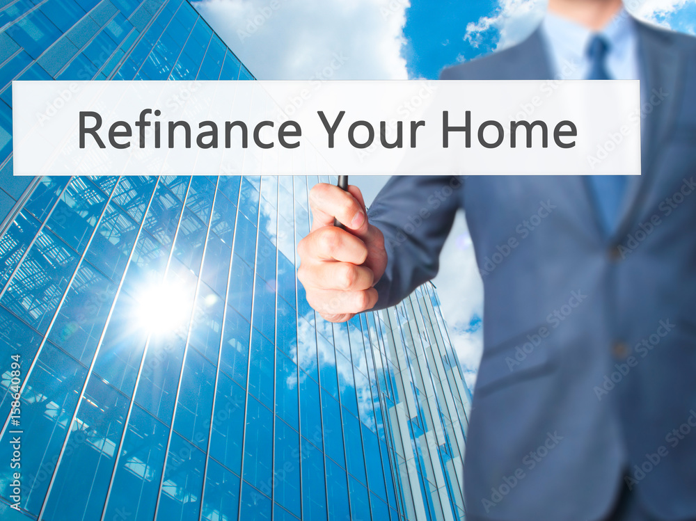 Refinance Your Home - Businessman hand holding sign Refinance Your Home - Businessman hand holding sign