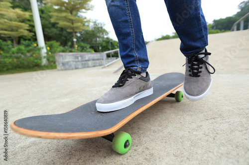 young skateboarder legs practicing at skatepark © lzf