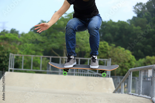 young woman skateboarder skateboarding at skatepark