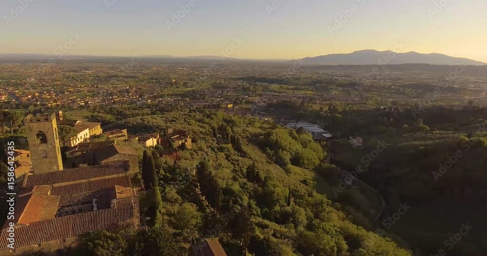 Aerial shot, a little ancient tuscan town on the hill in the sunset light in Italy, 4K Aerial shot, a little ancient tuscan town on the hill in the sunset light in Italy, 4K