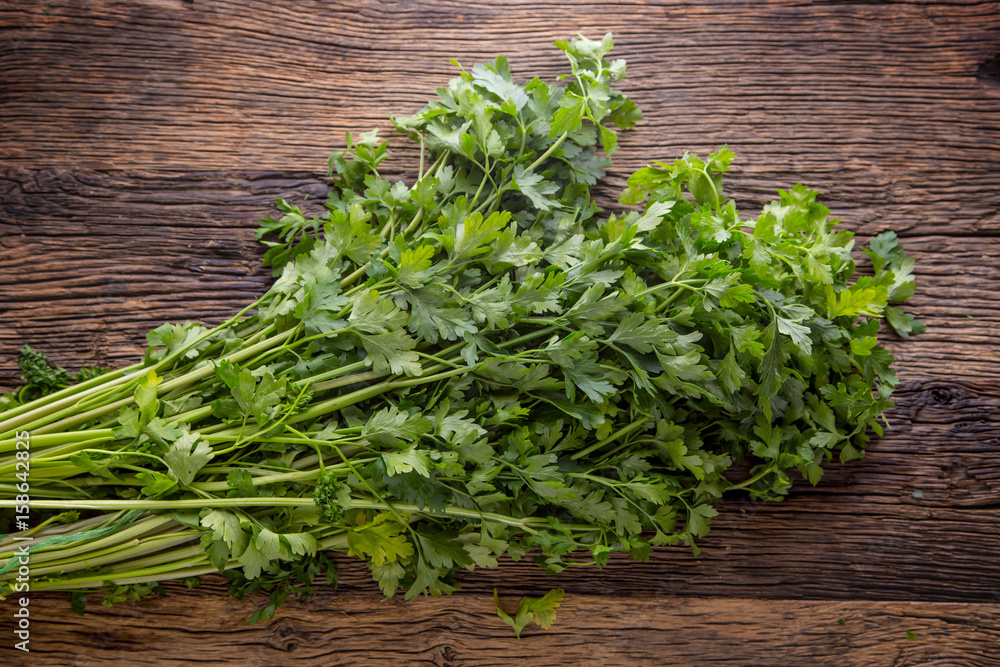 Parsnips leaves. Parsnips leaves on rustic oak table. Parsnips leaves. Parsnips leaves on rustic oak table.