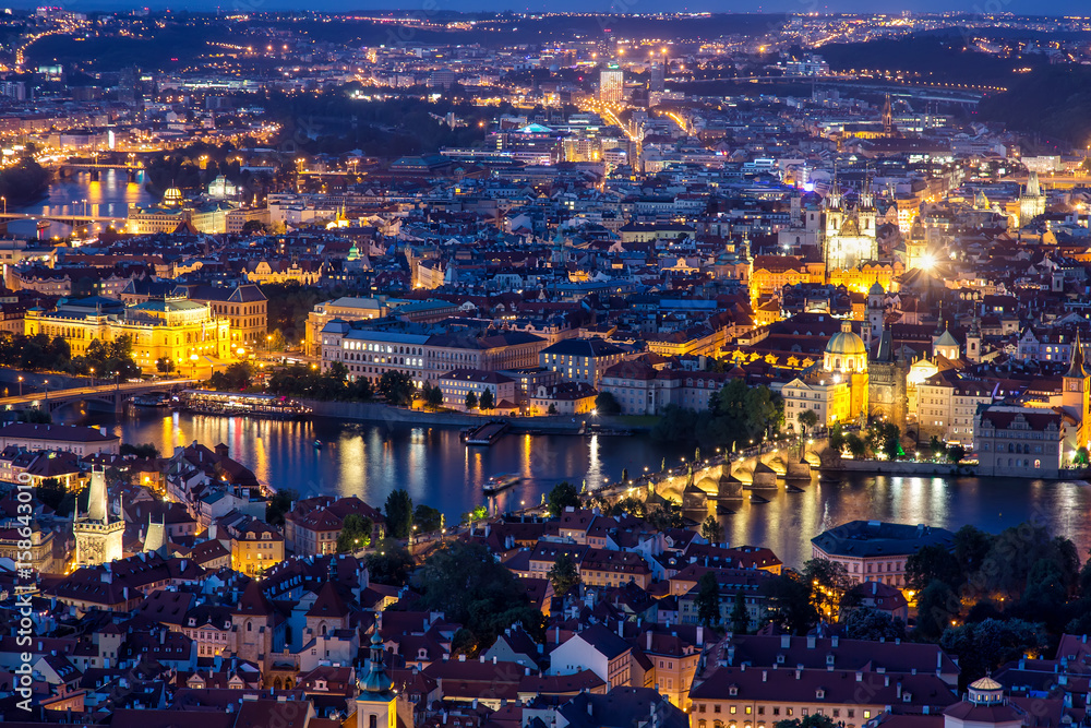 Prague at twilight blue hour, view of Charles Bridge on Vltava with Mala Strana and Old Town