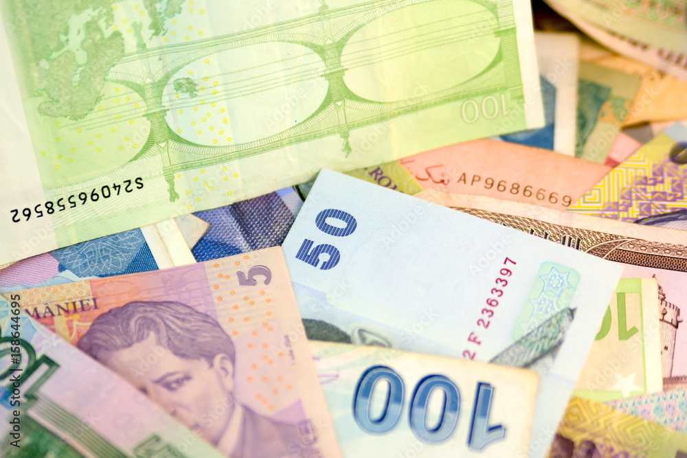 Different currency note and coins from different countries background ...