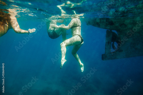 group of people swim underwater