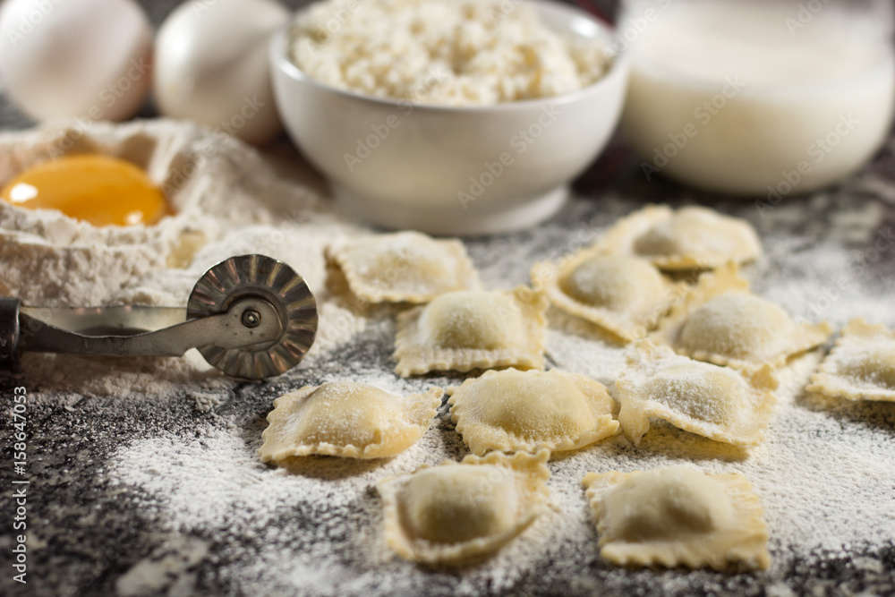 Italian food home made pasta ravioli on granite background.