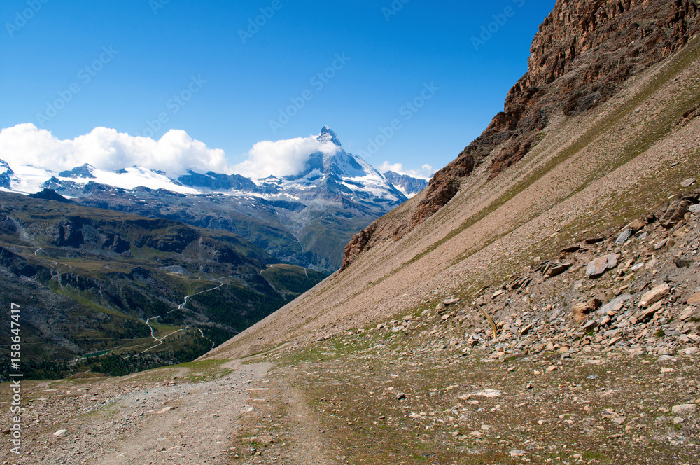A tourist path around the rocks overlooking the Matterhorn above the town of Zermatt in Switzerland A tourist path around the rocks overlooking the Matterhorn above the town of Zermatt in Switzerland