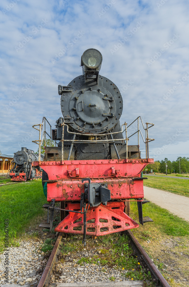 Naklejka premium Old steam locomotive train under blue sky
