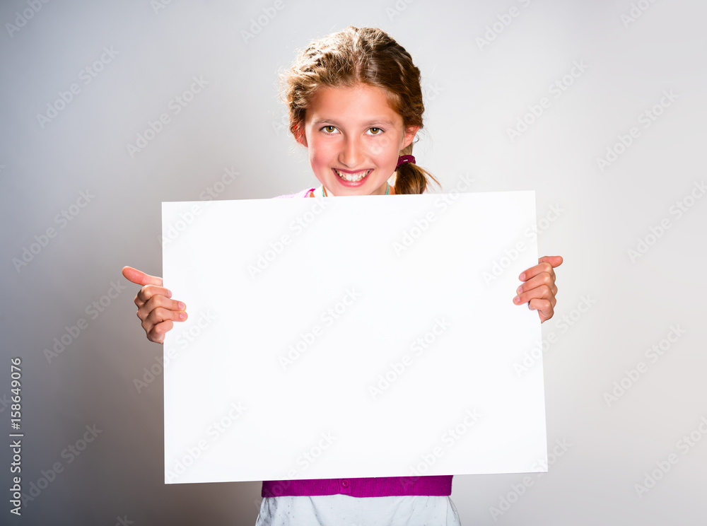 Cute girl with white sheet of paper Isolated on light background Cute girl with white sheet of paper Isolated on light background