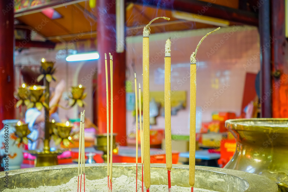 Burning incense inside a Buddhist temple in Kuala Lumpur