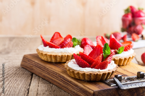 Vászonkép Strawberry shortcake pies on rustic wooden table