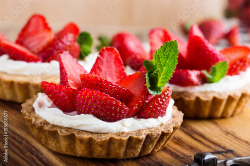 Strawberry shortcake pies on rustic wooden table photo