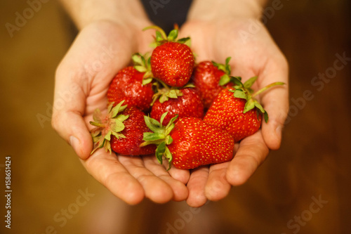 Strawberry on hands