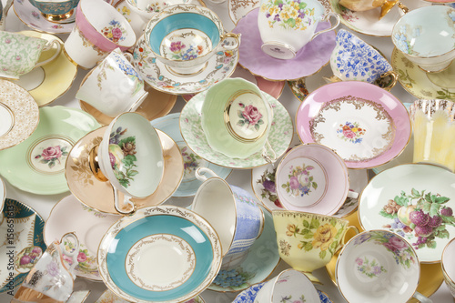 Beautiful vintage tea cups and saucers collection, isolated on a white background.