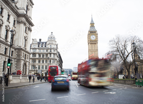 Fototapeta Naklejka Na Ścianę i Meble -  Traffic in Central London city, long exposure photo of red bus in motion, Big Ben in background