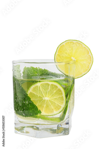 A refreshing drink in a glass with mint and lime isolate on a white background