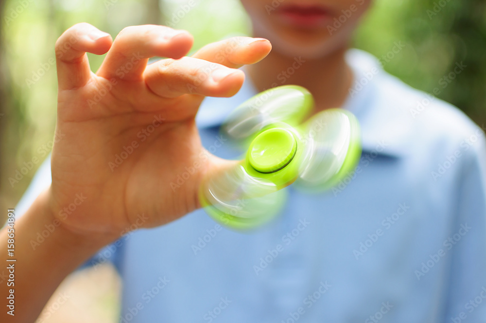 Boy playing with a Tri Fidget Hand Spinner Boy playing with a Tri Fidget Hand Spinner