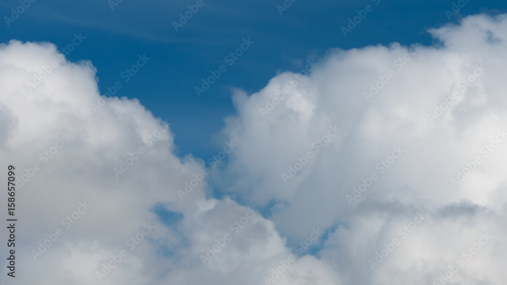 Fluffy,swirling clouds in the blue sky. Fluffy,swirling clouds in the blue sky.