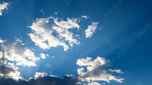 Blue Sky with White Clouds and Sun Rays shining through